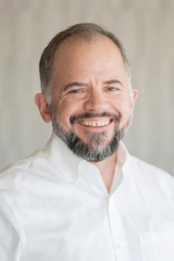 Man in white shirt smiling